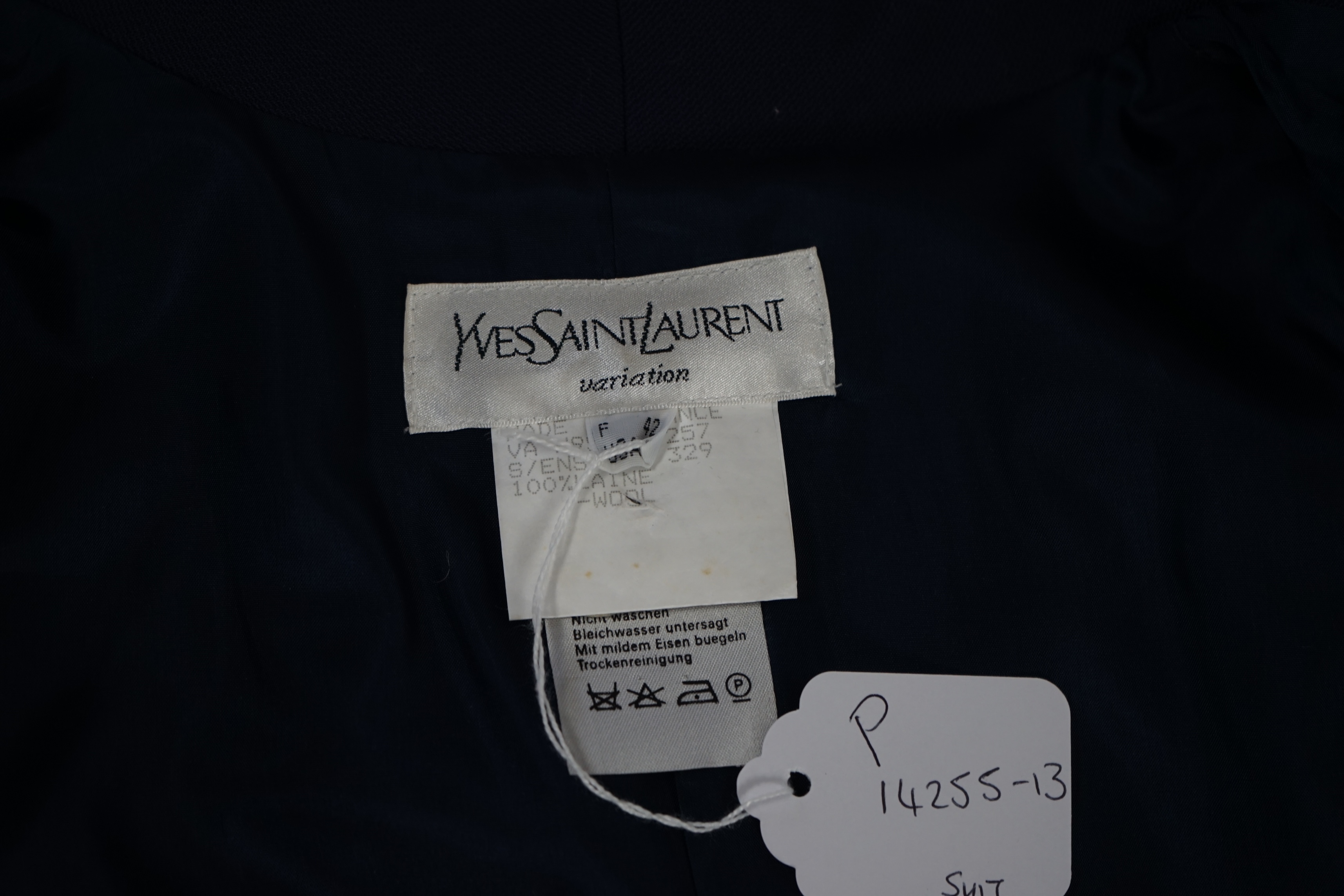 A vintage Yves Saint Laurent variation lady's navy wool skirt suit, F 42 (UK 14).Please note alterations to make the waist smaller may have been carried out on some of the skirts. Proceeds to Happy Paws Puppy Rescue.